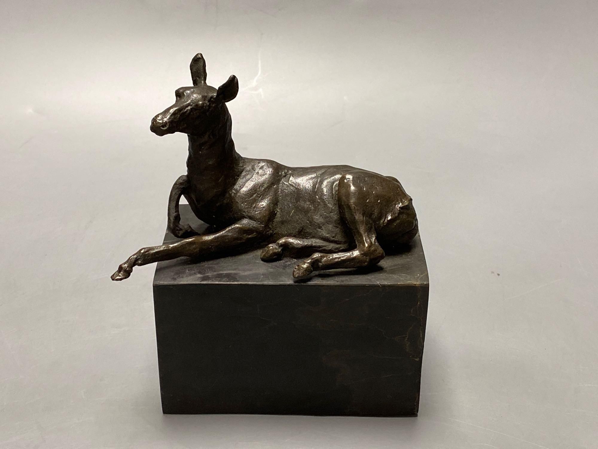 A bronze model of a recumbent mule, indistinctly signed, on marble plinth, width 12cm